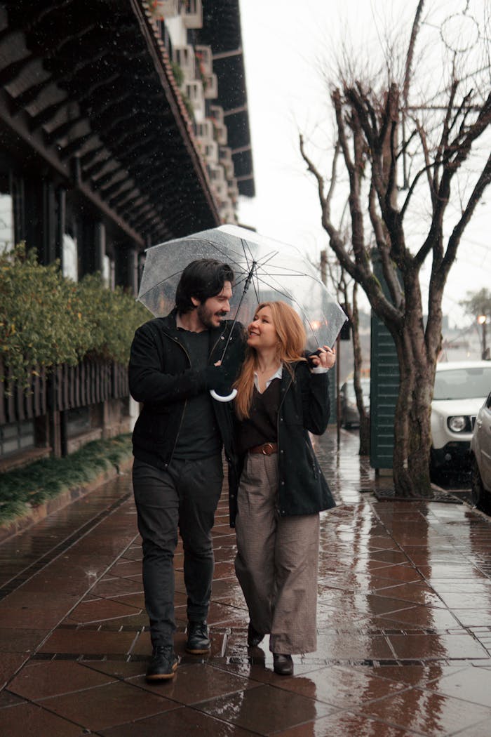 our-services-2 A couple shares an umbrella during a rainy day walk in Gramado, Brazil.